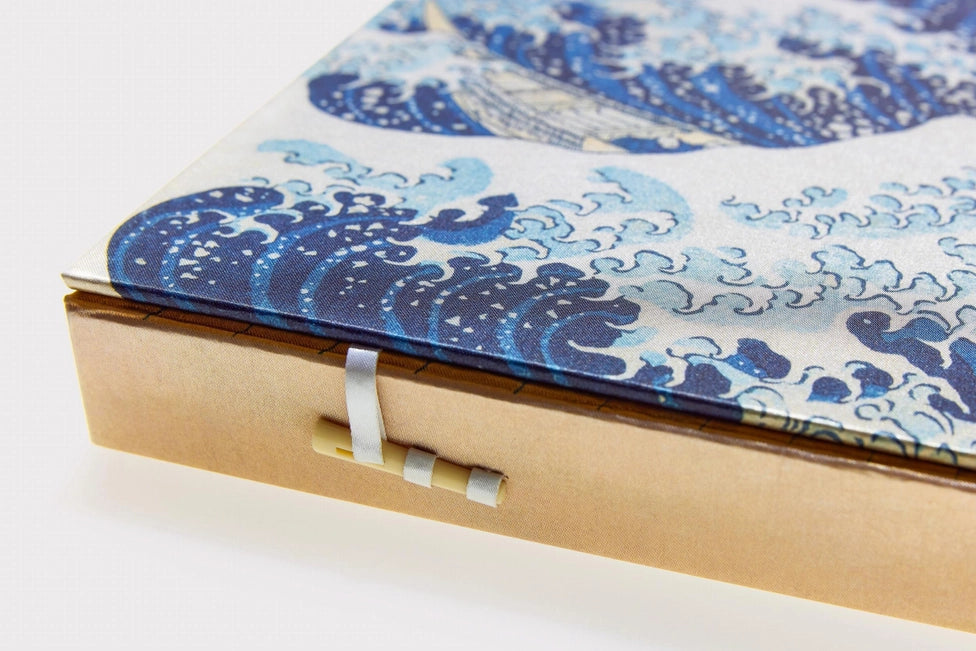 Blue and white patterned fabric inside a cardboard box