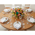 Set of colorful scalloped dinner napkins with different color borders on a white background