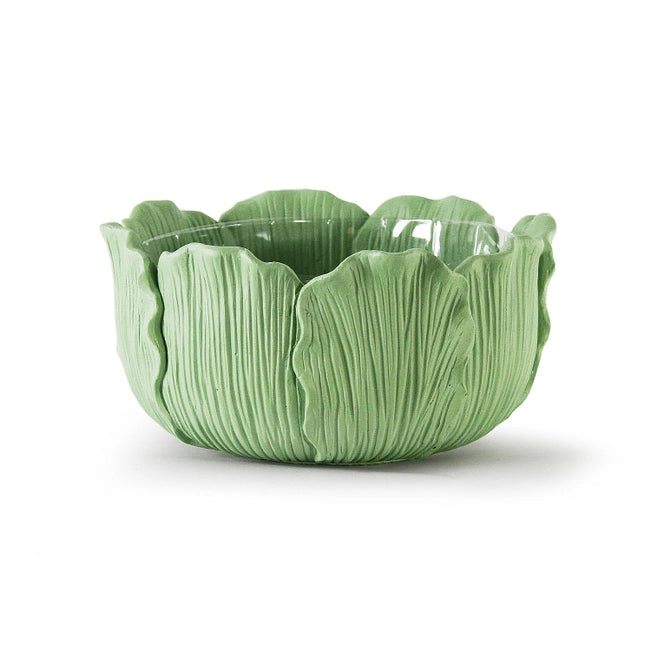 Green ceramic bowl with leaf-like design on a white background