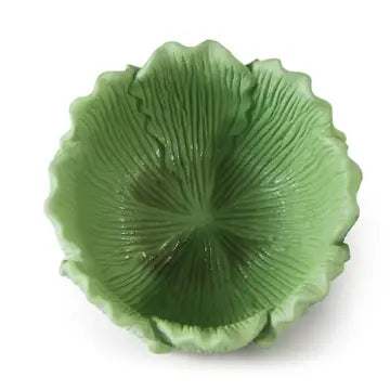 Green ceramic dish with textured surface on a white background