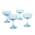 Set of four blue rounded coupe glasses against a white background.
