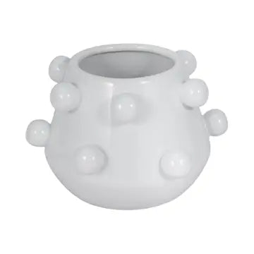 White ceramic vase with spherical protrusions on a white background