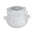 White ceramic vase with spherical protrusions on a white background